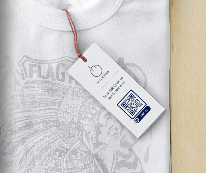 A clothing tag on a t-shirt with a QR Code that links to a Facebook page to increase likes and followers.