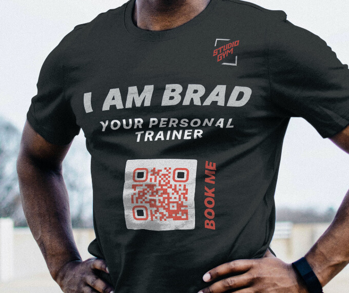 A t-shirt of a personal trainer with a QR Code that links to an online scheduling system.